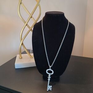 Long sliver necklace with sparkling key.